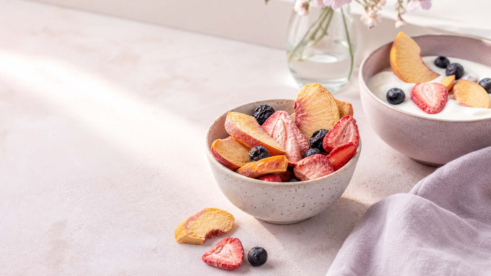 Soft pink and pale lavender kitchen scene with a bowl of crisp freeze-dried fruit and yogurt